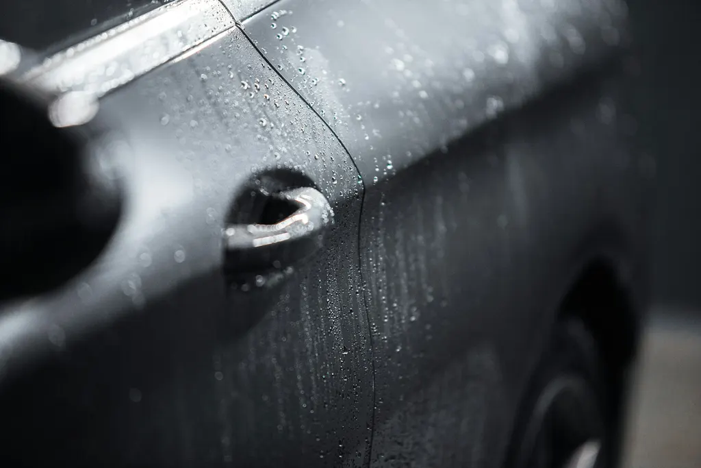 Water beading on automotive paint used to illustrate ceramic protection mood imagery, not a guaranteed coating outcome.