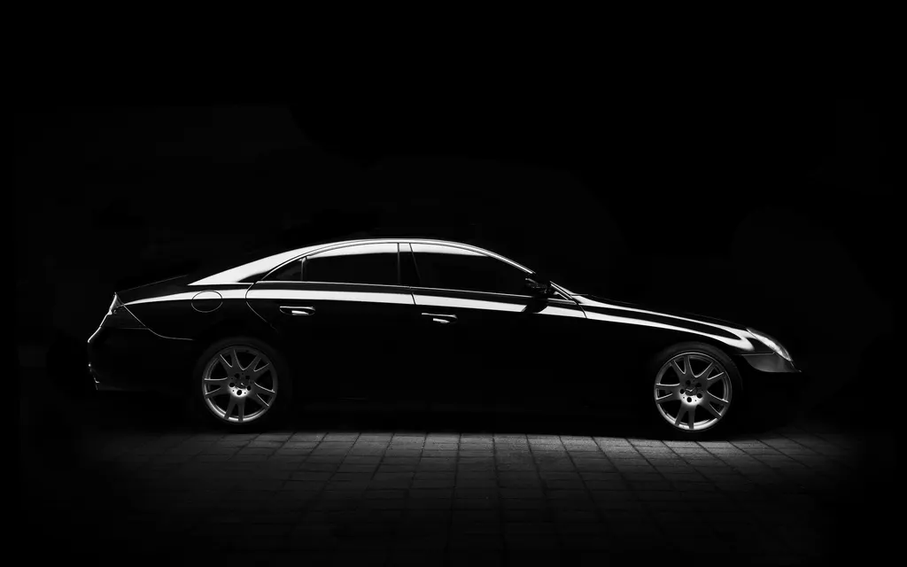 Atmospheric close view of glossy dark automotive paint with reflections, used as detailing mood imagery rather than a completed Joker Auto Detailing project.
